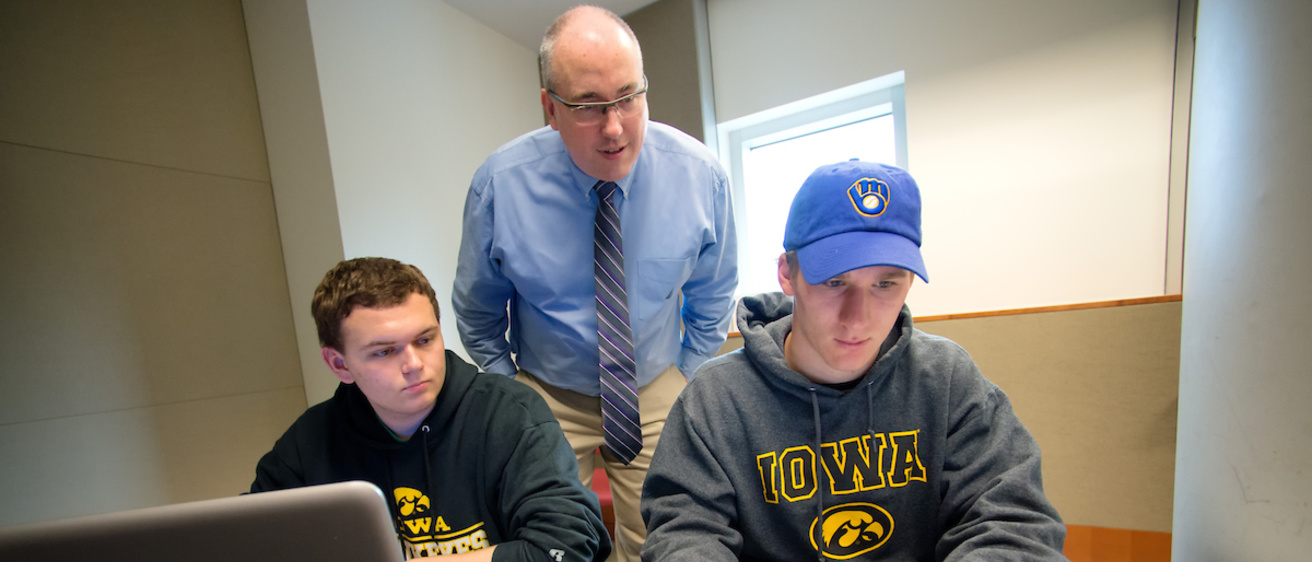 Gary Christensen talks with two students